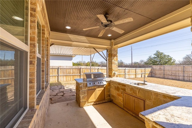 view of patio featuring exterior kitchen, sink, and grilling area