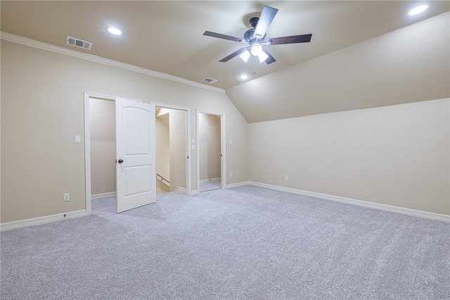 unfurnished bedroom featuring ceiling fan, light colored carpet, lofted ceiling, and ornamental molding