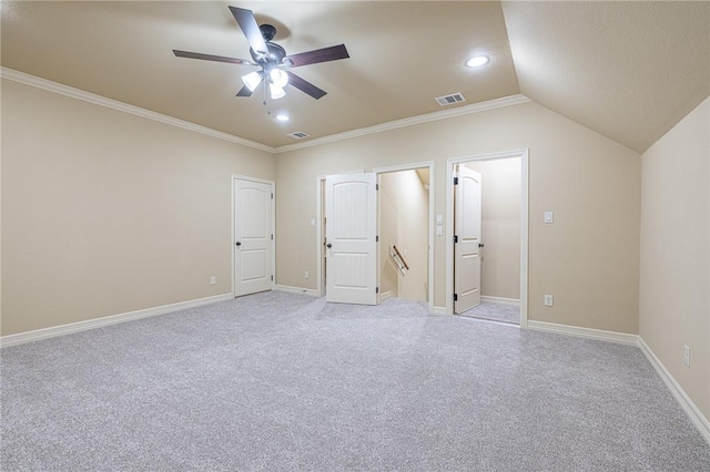 unfurnished bedroom with lofted ceiling, crown molding, light colored carpet, and ceiling fan