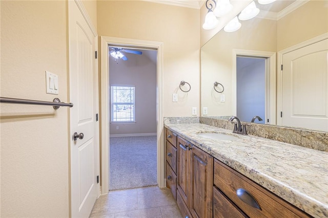 bathroom featuring crown molding, tile patterned floors, and vanity