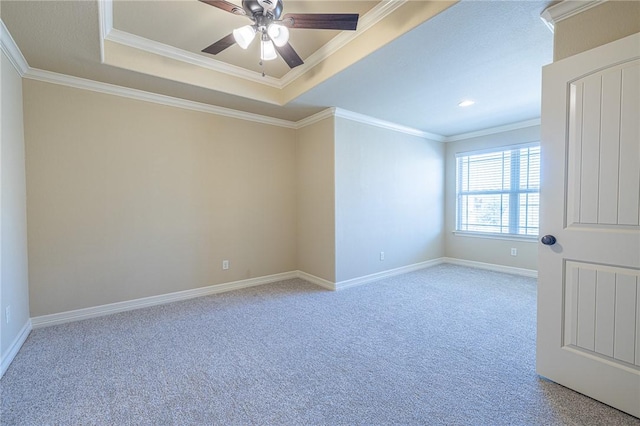 unfurnished room with light carpet, ornamental molding, a raised ceiling, and ceiling fan