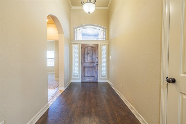 entryway with crown molding and dark hardwood / wood-style flooring