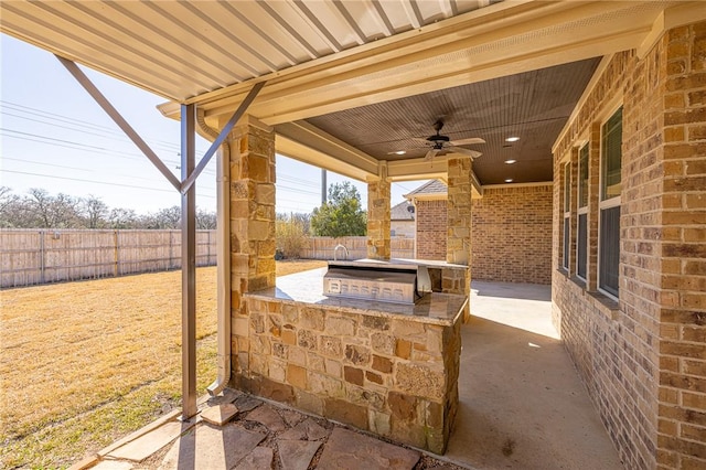 view of patio with ceiling fan and exterior kitchen