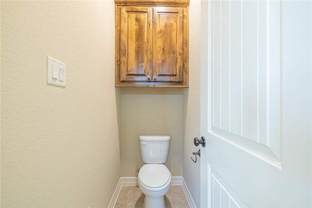 bathroom featuring tile patterned flooring and toilet