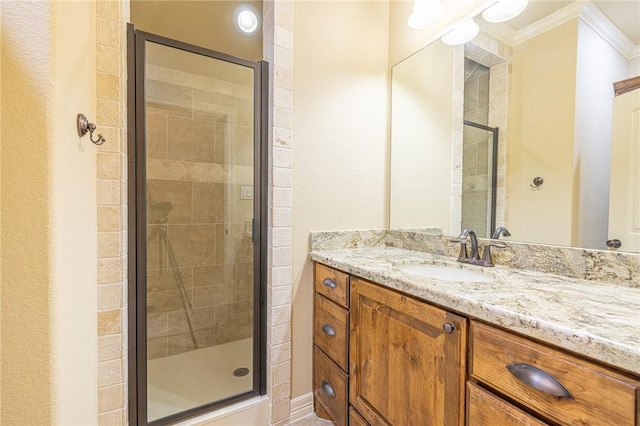 bathroom featuring walk in shower, ornamental molding, and vanity