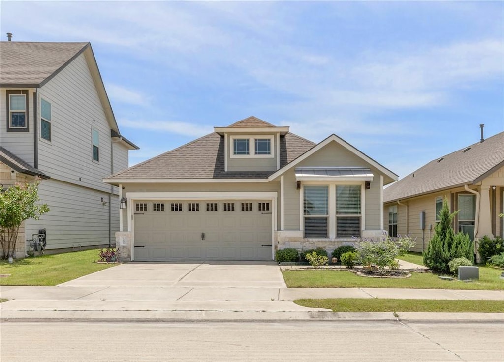 1058 Toledo Bend Dr, College Station, TX 77845 - view of front facade with roof with shingles, driveway, an attached garage, and a front yard