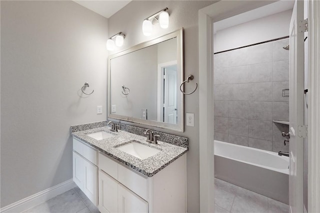 bathroom with vanity, tiled shower / bath, and tile patterned flooring