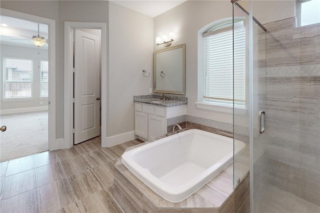 bathroom featuring ceiling fan, vanity, and separate shower and tub