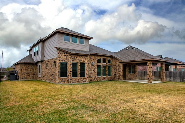 rear view of property featuring a patio area, central AC unit, and a lawn