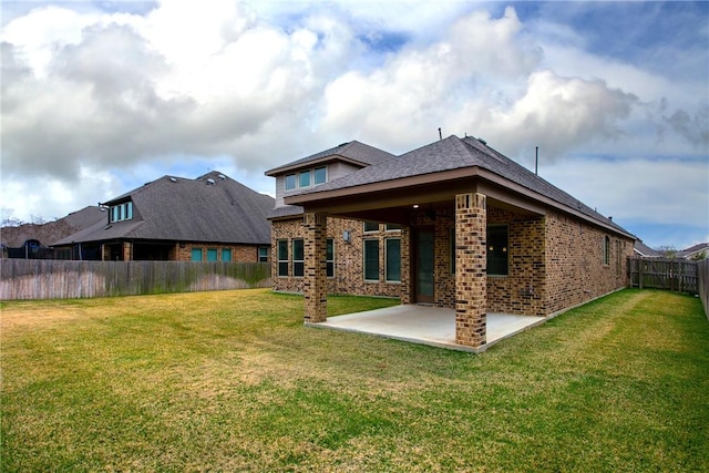 back of property featuring a lawn and a patio