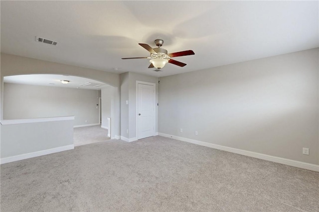 carpeted spare room featuring ceiling fan