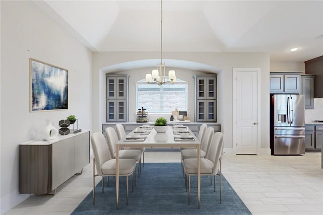 dining room featuring a chandelier and vaulted ceiling