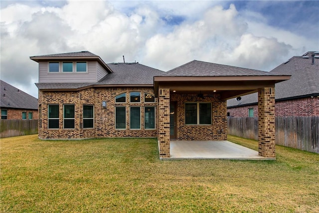 back of house featuring a patio area and a lawn