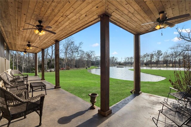 view of patio / terrace featuring ceiling fan and a water view