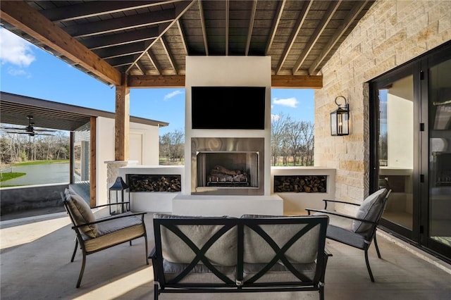 view of patio featuring exterior fireplace