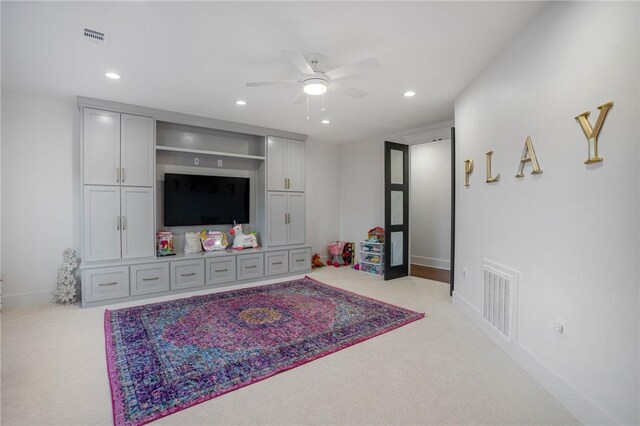 living room with light carpet and ceiling fan