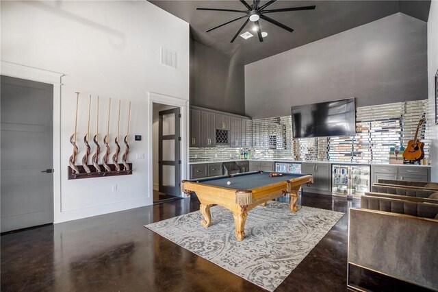 game room with ceiling fan, a high ceiling, and pool table