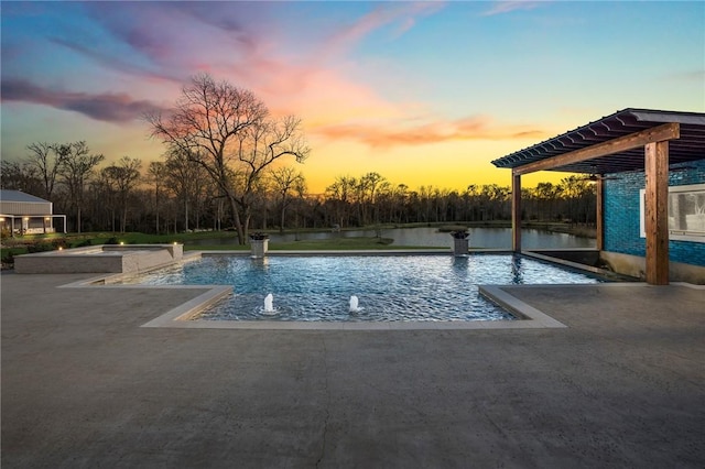 pool at dusk with pool water feature and a patio