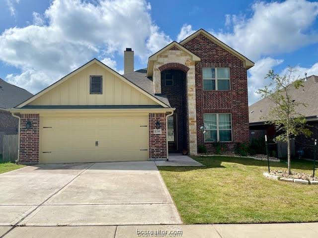 6336 Spartan Dr, College Station, TX 77845 - traditional home with brick siding, a garage, and board and batten siding