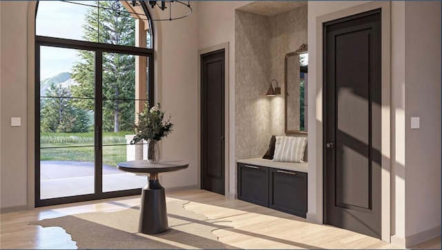 entryway with an inviting chandelier and light wood-type flooring