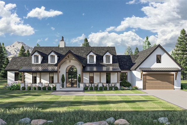 view of front facade with a garage, a mountain view, covered porch, and a front lawn