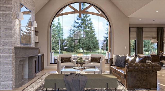 living room with lofted ceiling, an outdoor brick fireplace, and a wealth of natural light