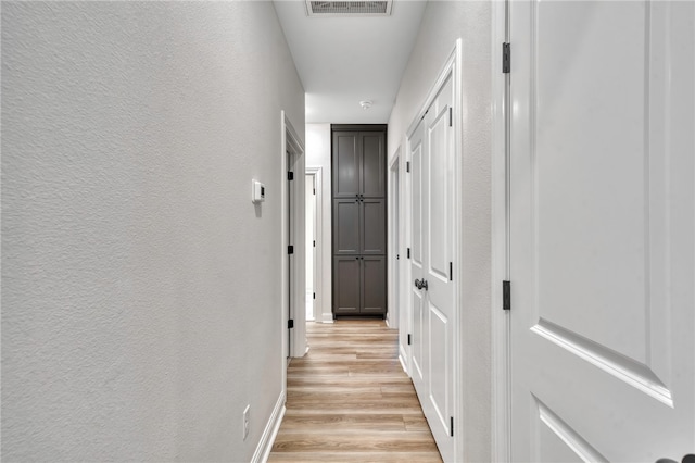 corridor with light wood-type flooring