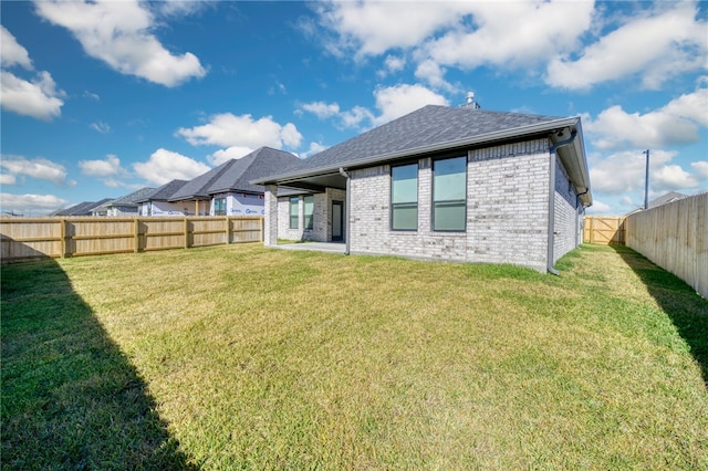 back of house with a lawn