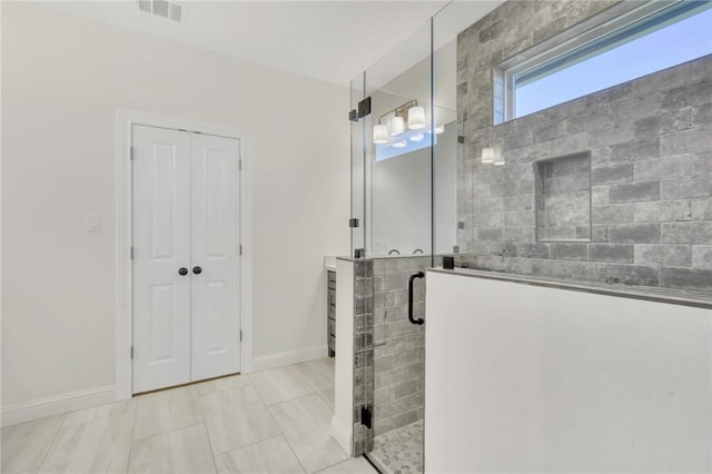 bathroom with tile patterned floors and walk in shower