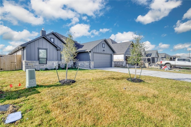 view of front of house with a front yard and a garage