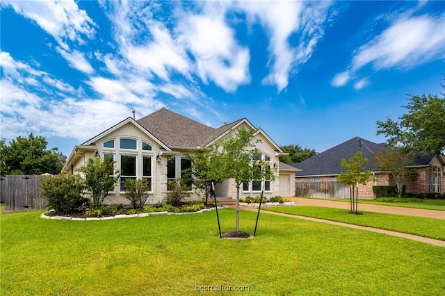 view of front of house with a garage and a front lawn