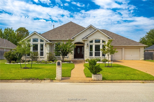 view of front of property with a front yard and a garage