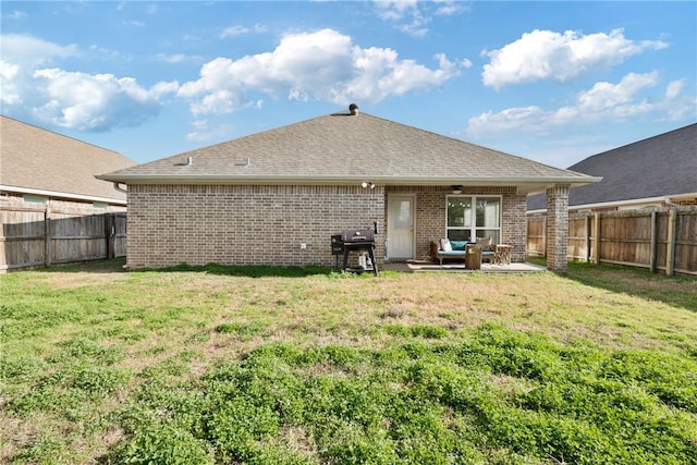 back of house with a patio area and a lawn