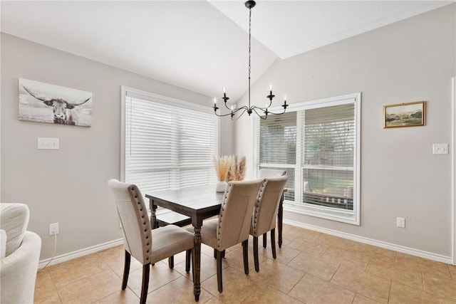 tiled dining room featuring a healthy amount of sunlight, a chandelier, and vaulted ceiling