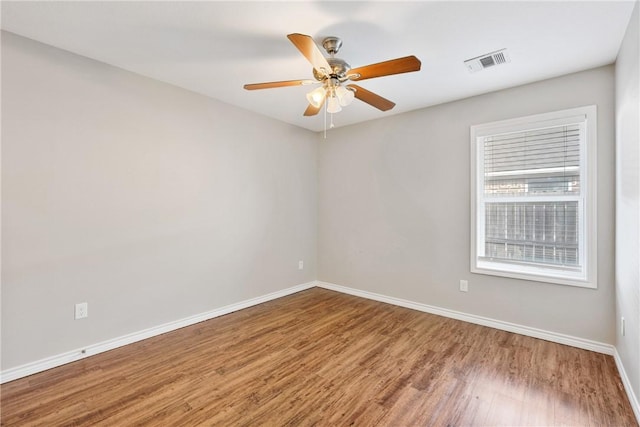 empty room with hardwood / wood-style floors and ceiling fan