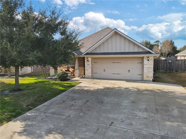 view of front of property with a garage and a front lawn