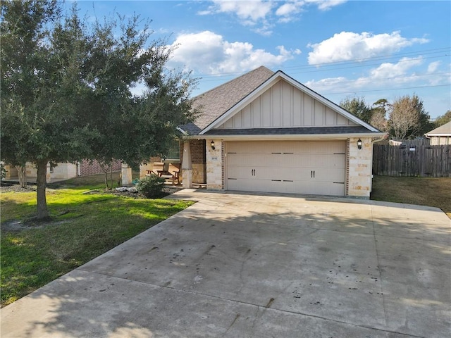 view of front of property featuring a garage and a front yard