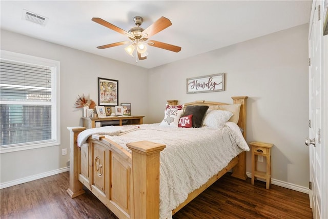 bedroom with dark hardwood / wood-style floors and ceiling fan