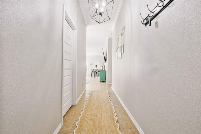 corridor with a chandelier and light tile patterned floors