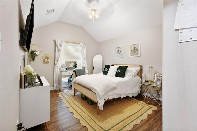 bedroom featuring ceiling fan, lofted ceiling, and dark hardwood / wood-style flooring