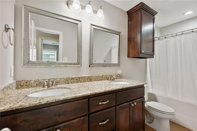 full bathroom featuring vanity, shower / bath combination with curtain, and toilet