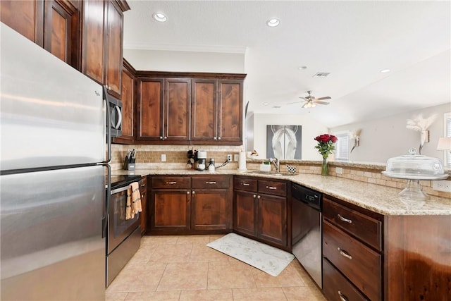 kitchen with sink, backsplash, light tile patterned floors, stainless steel appliances, and light stone countertops