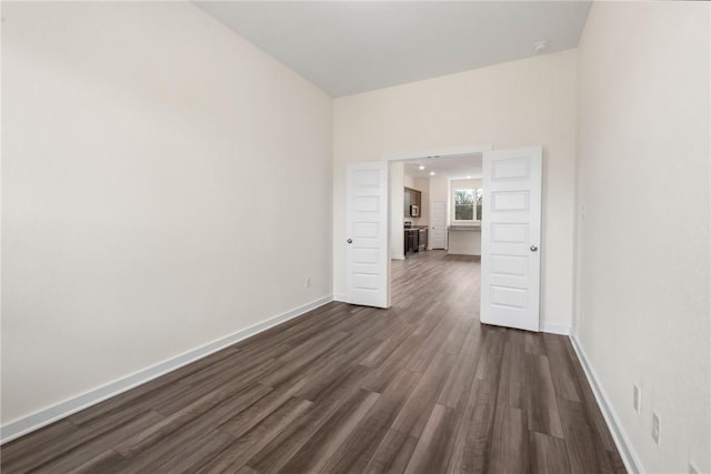 spare room with dark hardwood / wood-style floors