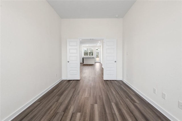 unfurnished room featuring dark hardwood / wood-style flooring