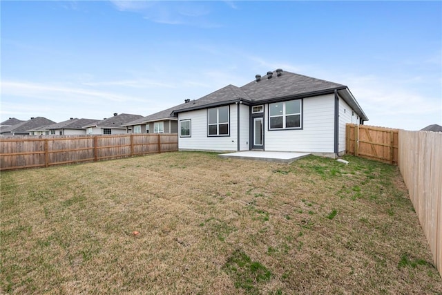 rear view of house with a lawn and a patio area