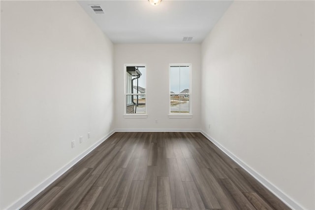 unfurnished room featuring dark wood-type flooring