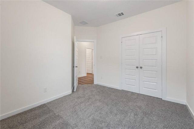 unfurnished bedroom featuring carpet floors and a closet