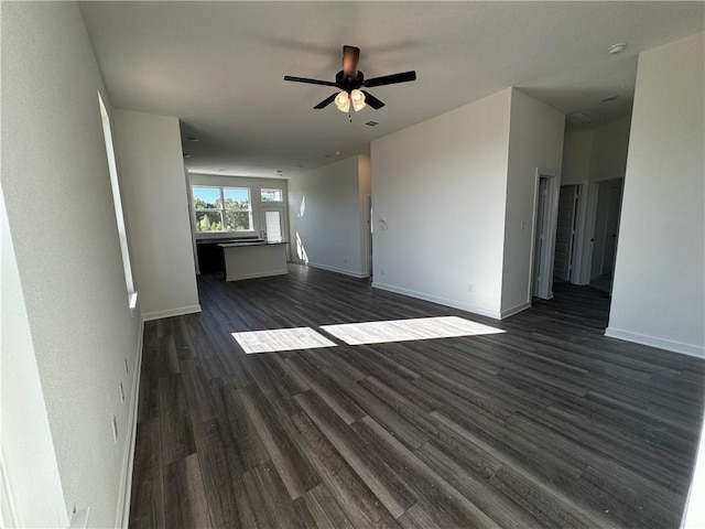 unfurnished living room featuring ceiling fan and dark hardwood / wood-style floors