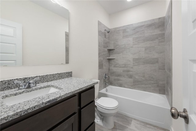 full bathroom featuring tiled shower / bath combo, vanity, and toilet