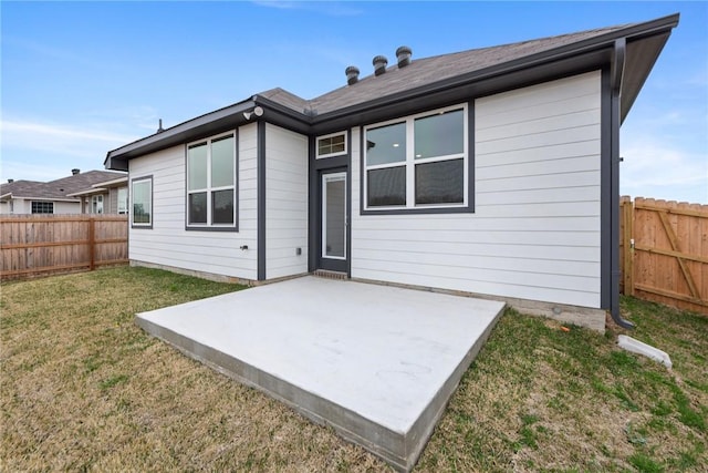 back of property featuring a yard and a patio area